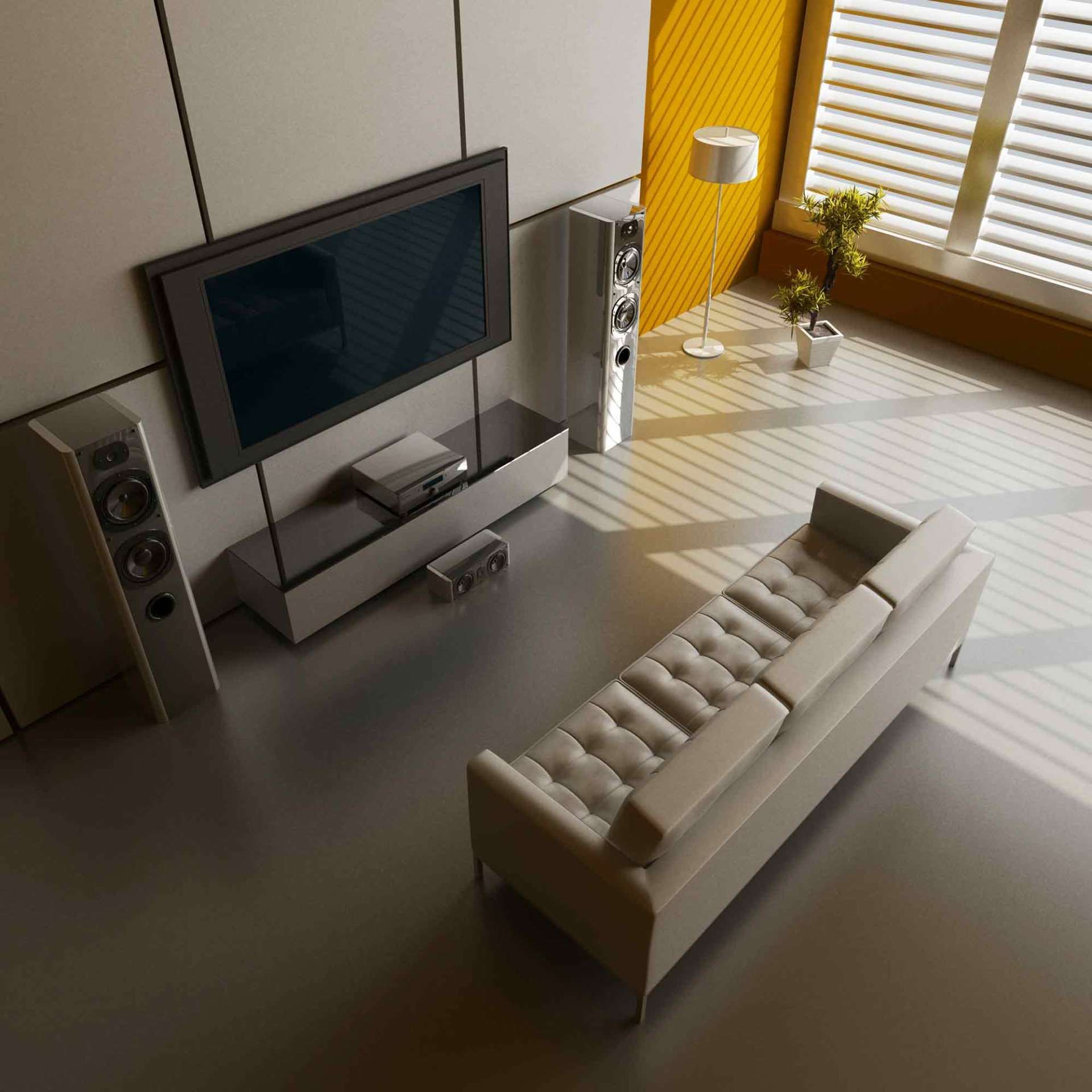 A living room with a couch a television and speakers