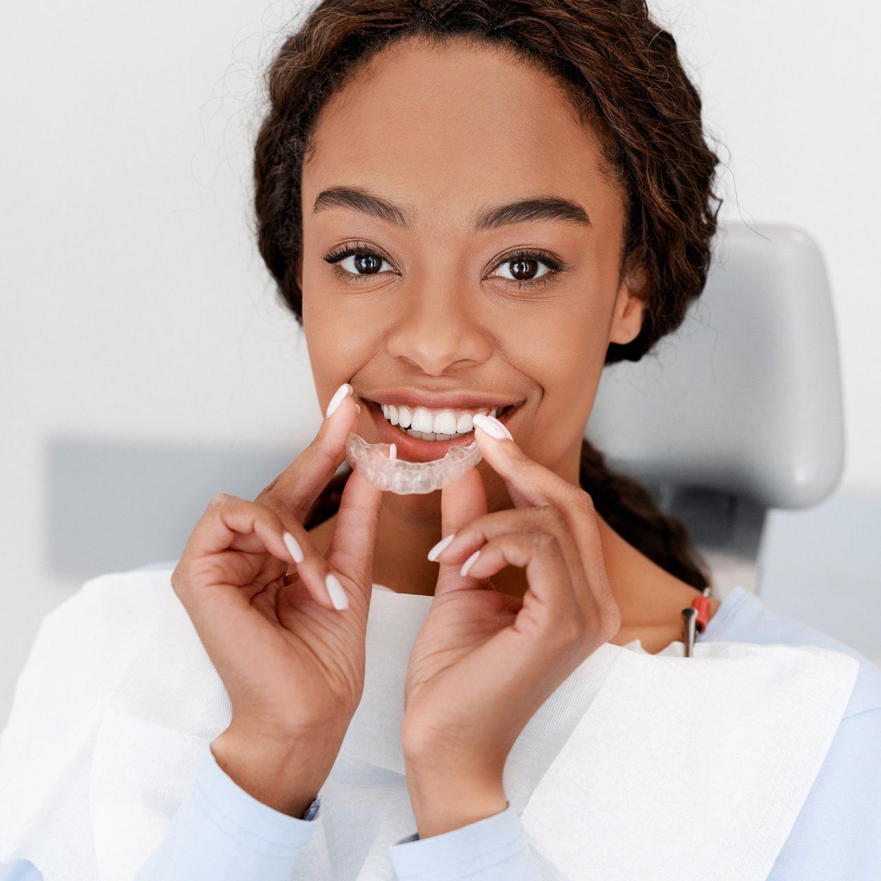Happy Woman Holding Her Invisalign — Frankfort, IL — Brookside Dental Care