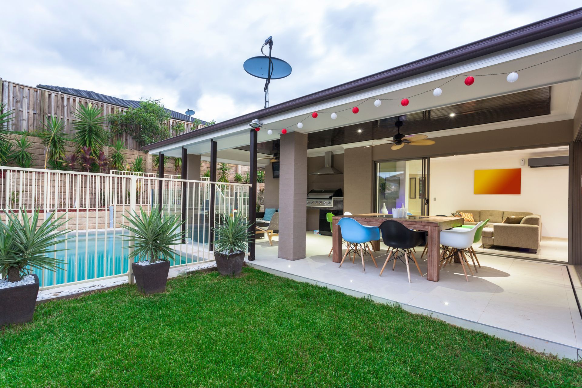 There is a swimming pool in the backyard of a house.