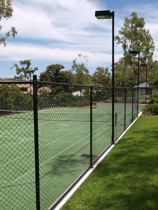 A tennis court with a chain link fence around it