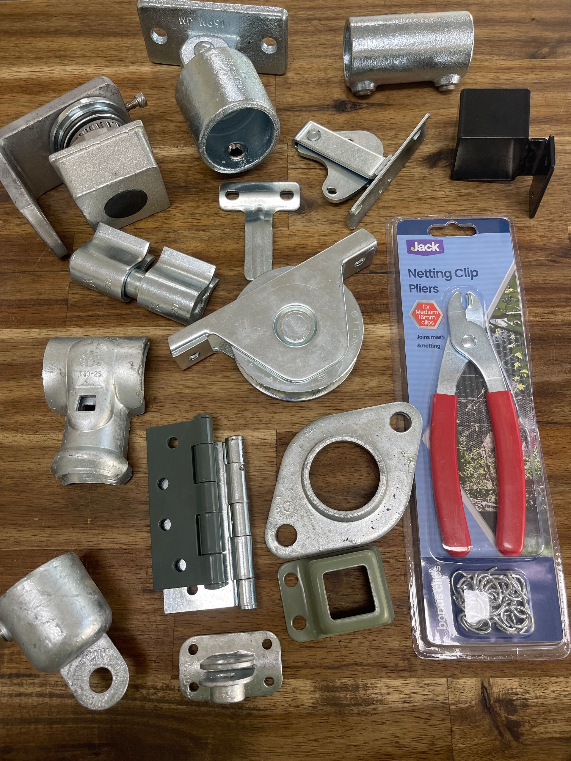 A bunch of metal parts are sitting on a wooden table.