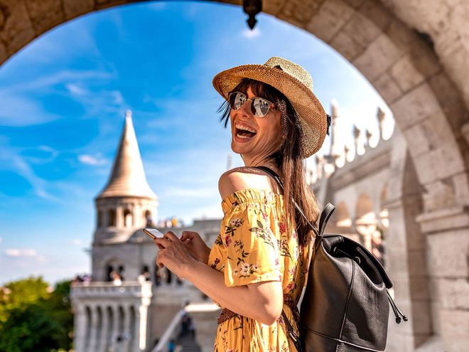 Smiling traveler with a castle tower in the background