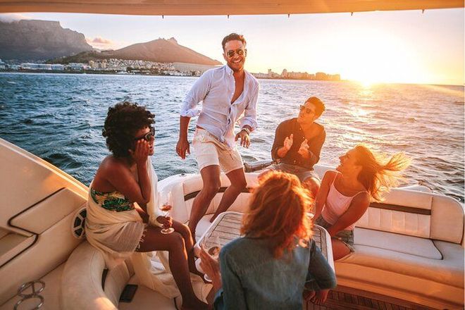 Friends relaxing on a boat at sunset