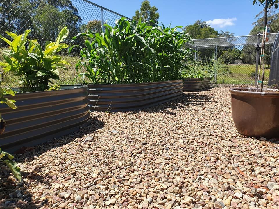 A Large Metal Tank is Sitting in Front of a House — Foley's Tanks in Noosa, QLD