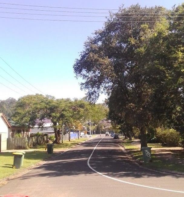 A Street With Trash Cans on the Side of It and Trees on the Side of the Road — Foley's Tanks in Nambour, QLD