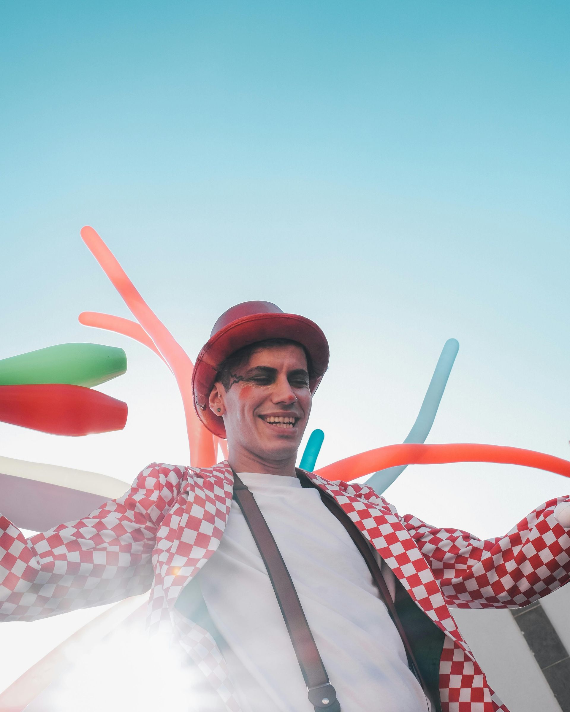 A clown, juggler, and ballon animal artist