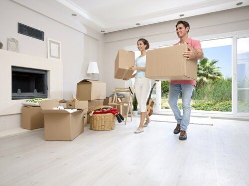Couple Carrying Moving Boxes - Moving Services in Papillion, NE