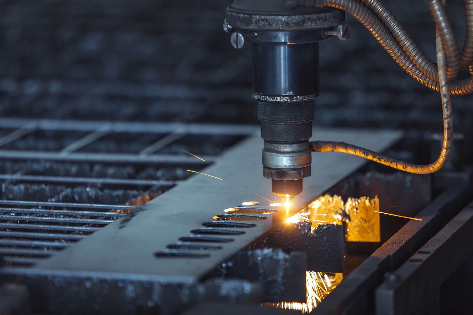 Close-up of CNC laser cutting metal sheet, showcasing precise cutting technology in industry.