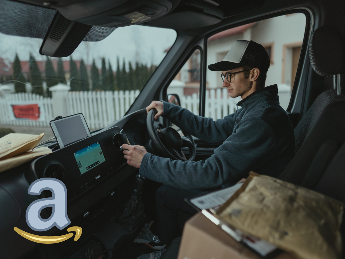 A delivery driver in a hat and glasses sits in a parked van, adjusting the GPS navigation screen.