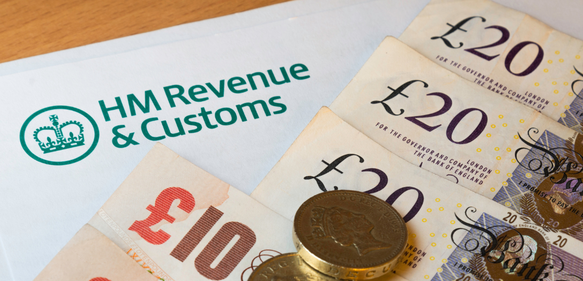 HM Revenue & Customs document next to several British twenty and ten-pound notes and coins.