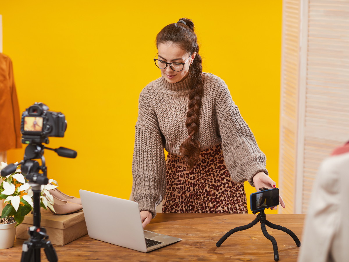 Woman with cameras and a laptop