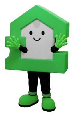 A mascot shaped like a green house with a smiling face, waving both hands while standing on two legs.