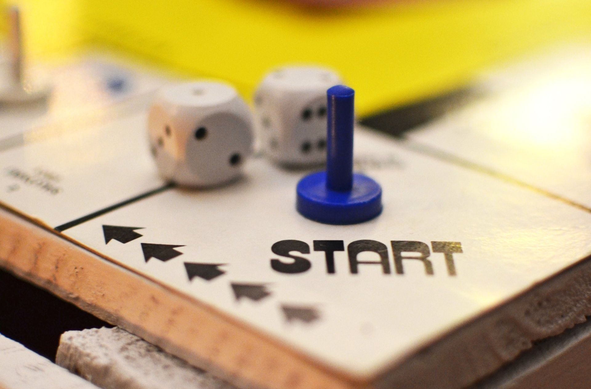 A blue game piece sits on a board game space marked 