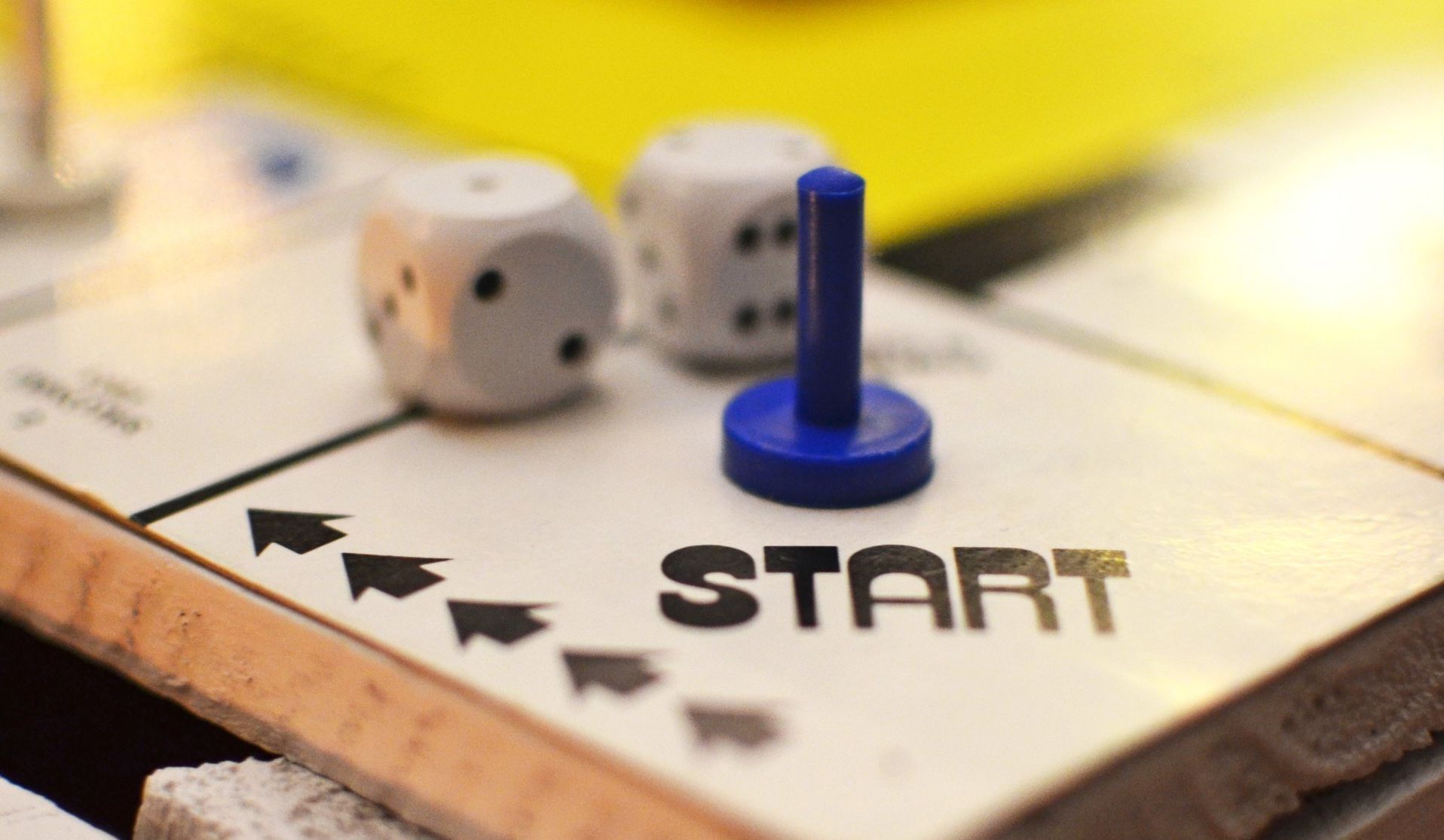 A blue game piece sits on a board game space marked 