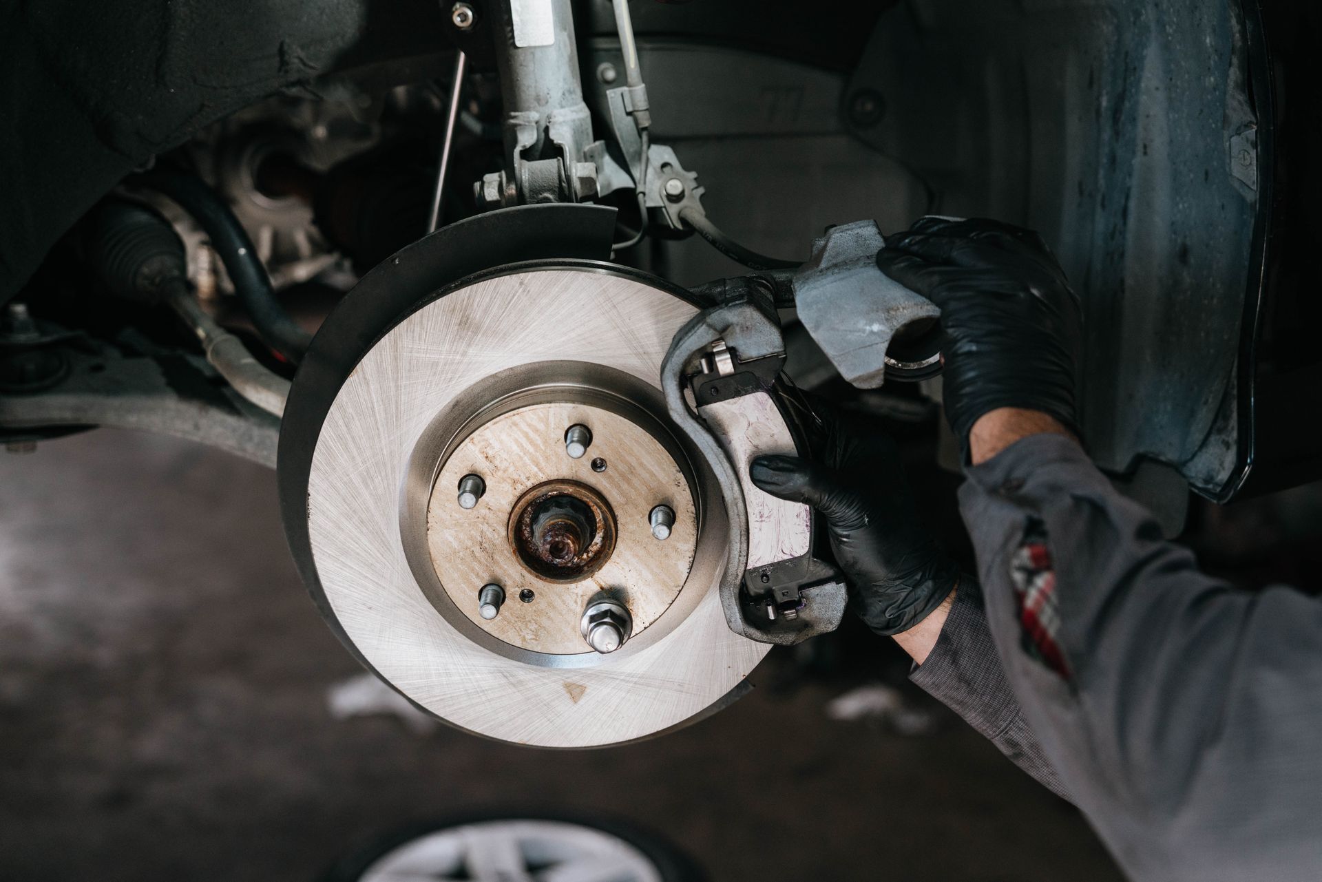 Technician performing RV brake replacement services in the Escondido shop.