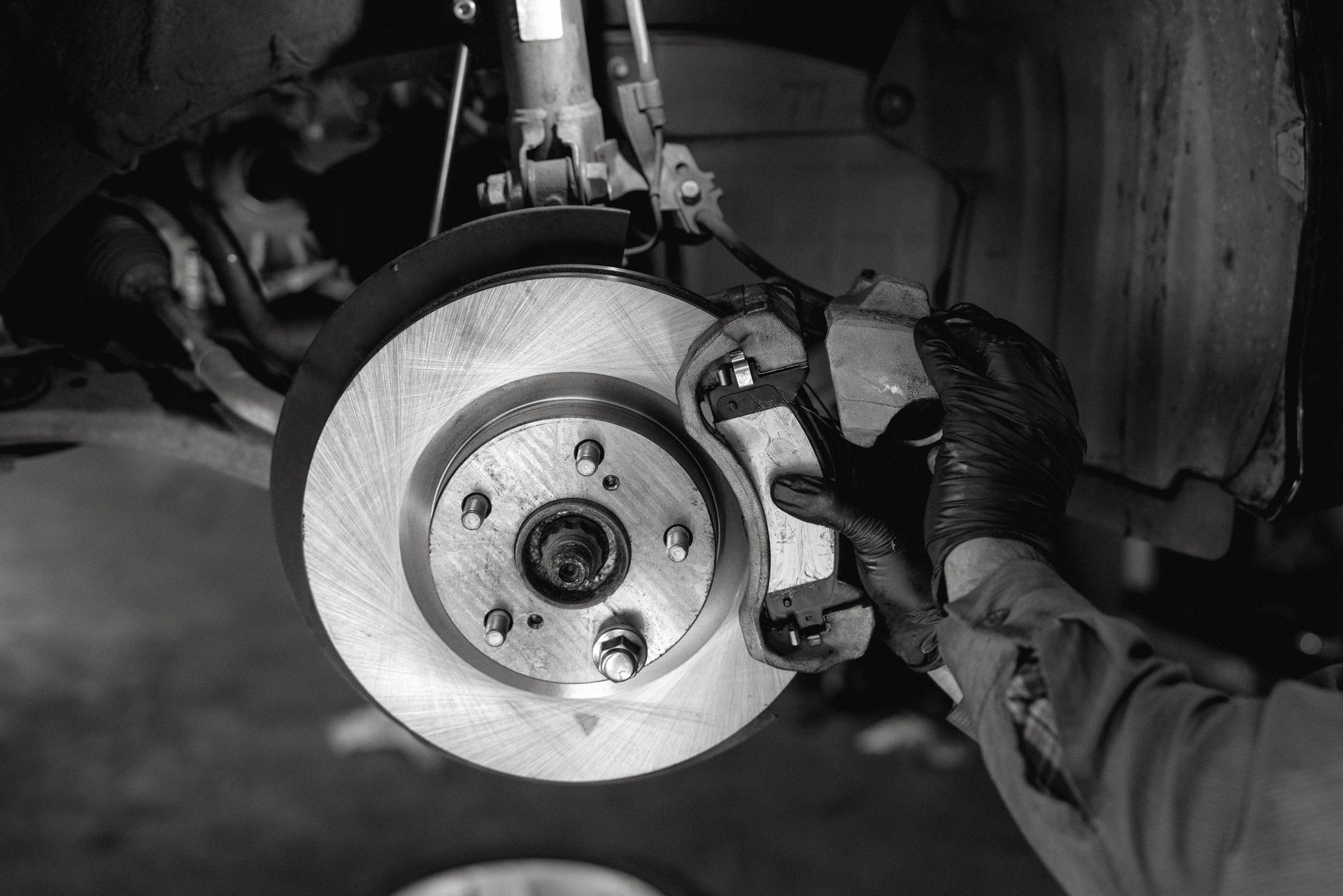 A skilled mechanic performing a professional brake replacement on a car.