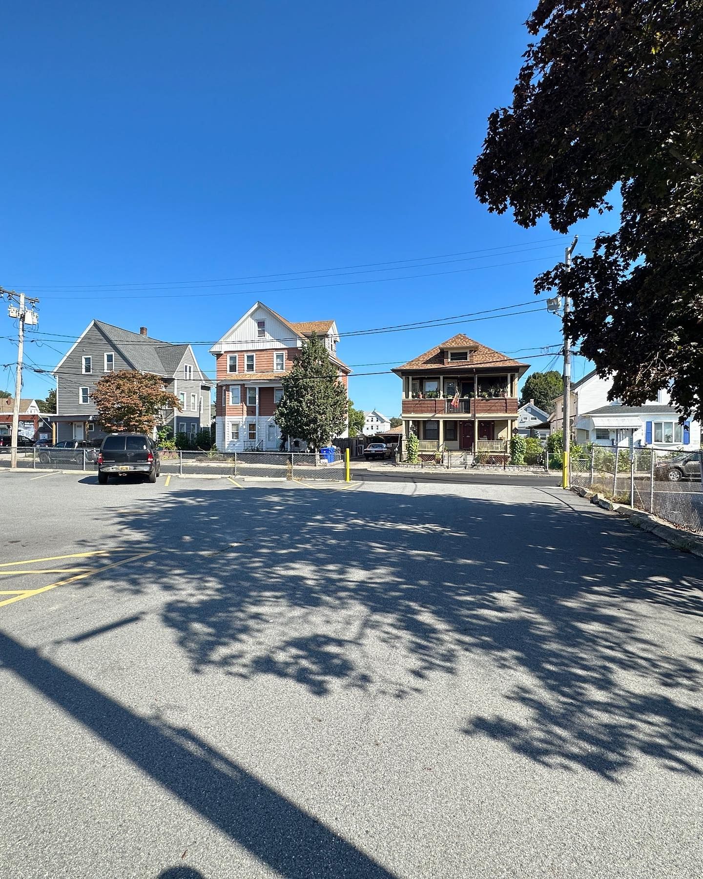Parking Lot In Front Of A Row Of Houses — Cumberland, RI — Sharpeye Home & Commercial Property Inspections