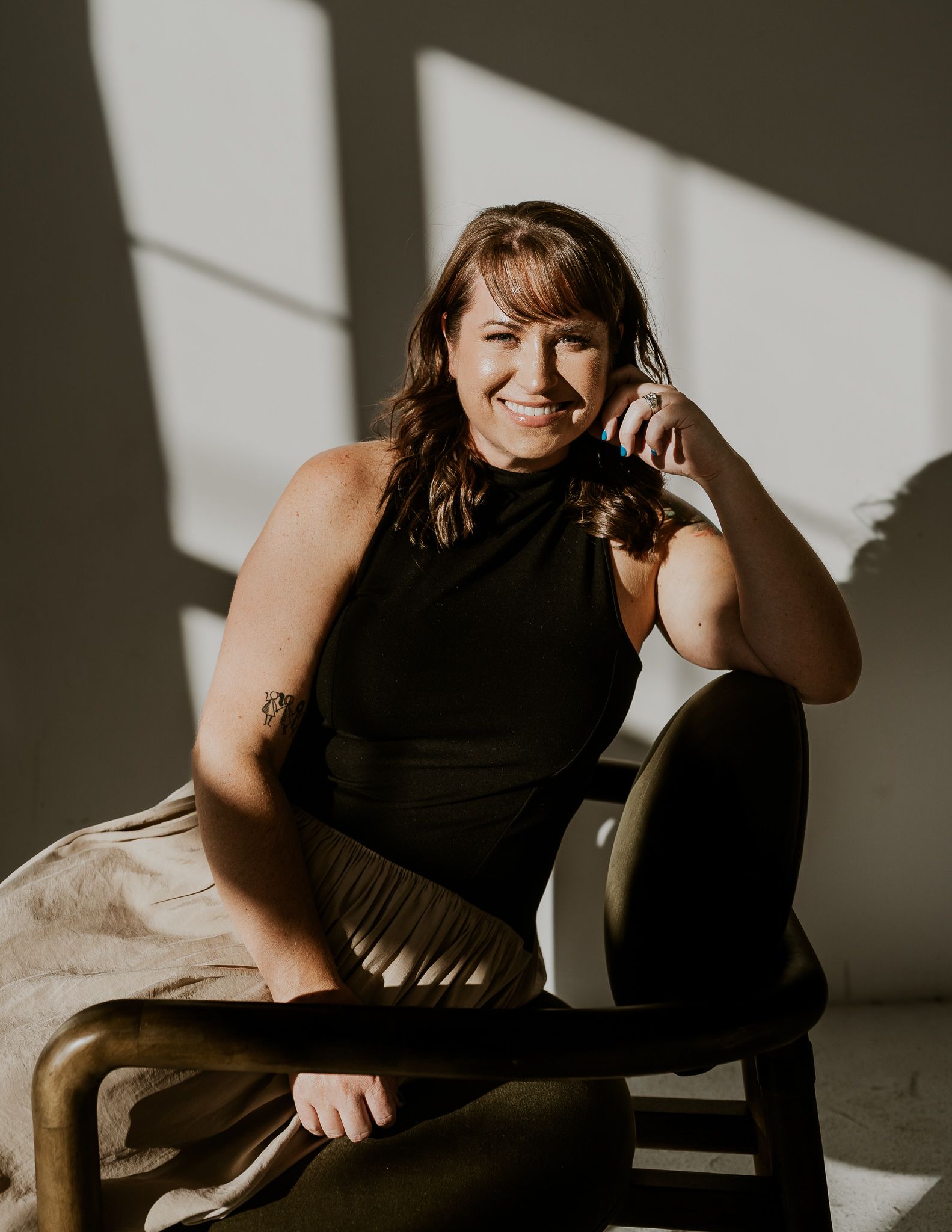 A woman sitting in a chair in a studio.