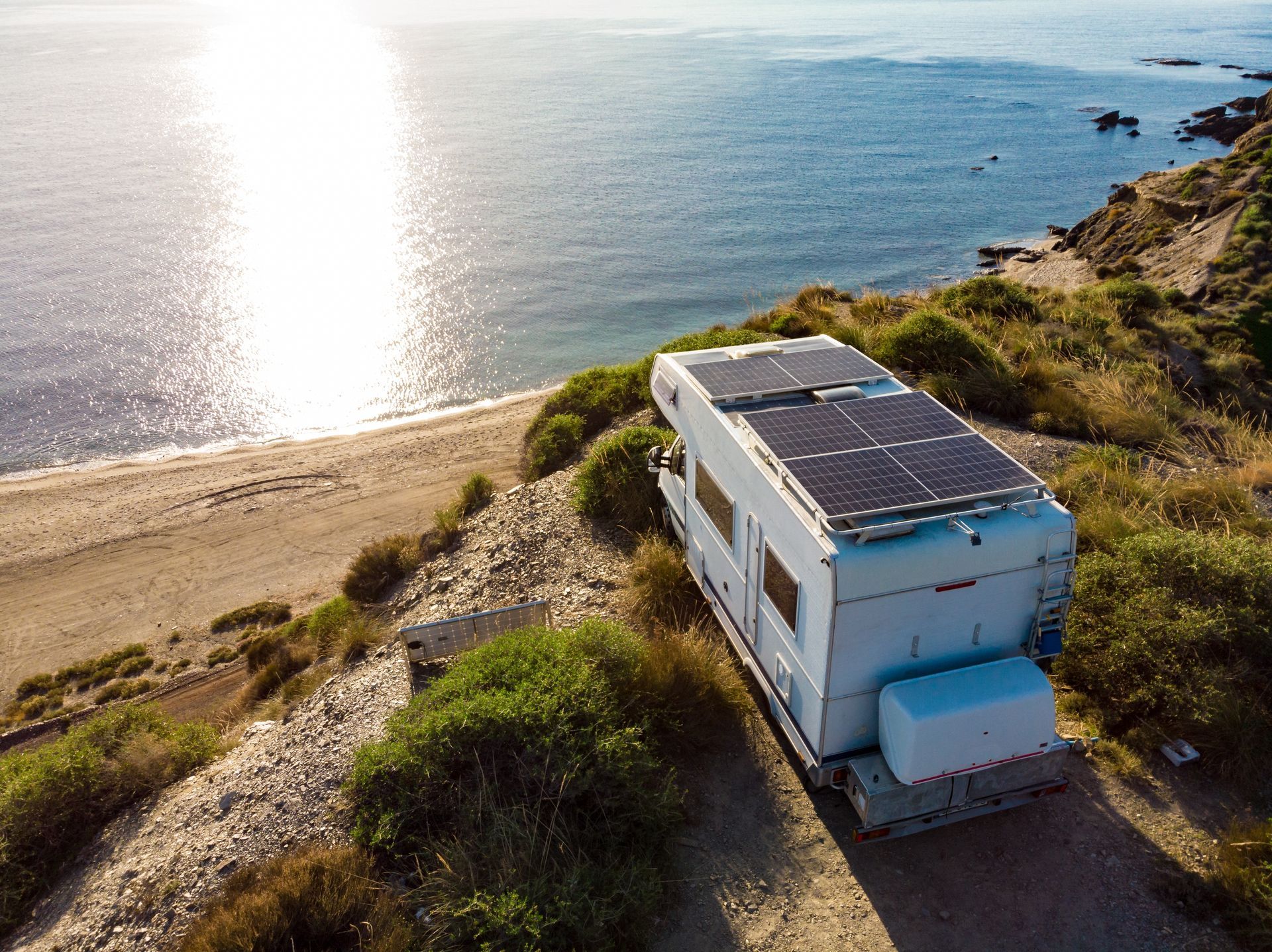 Rv With Solar Panels Parked on a Cliff Overlooking — G&S Caravan Services in Taylors Beach, NSW