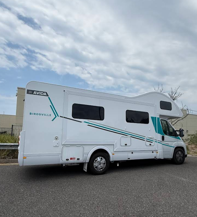 White Rv on Asphalt Road, Teal Accents — G&S Caravan Services in Taylors Beach, NSW