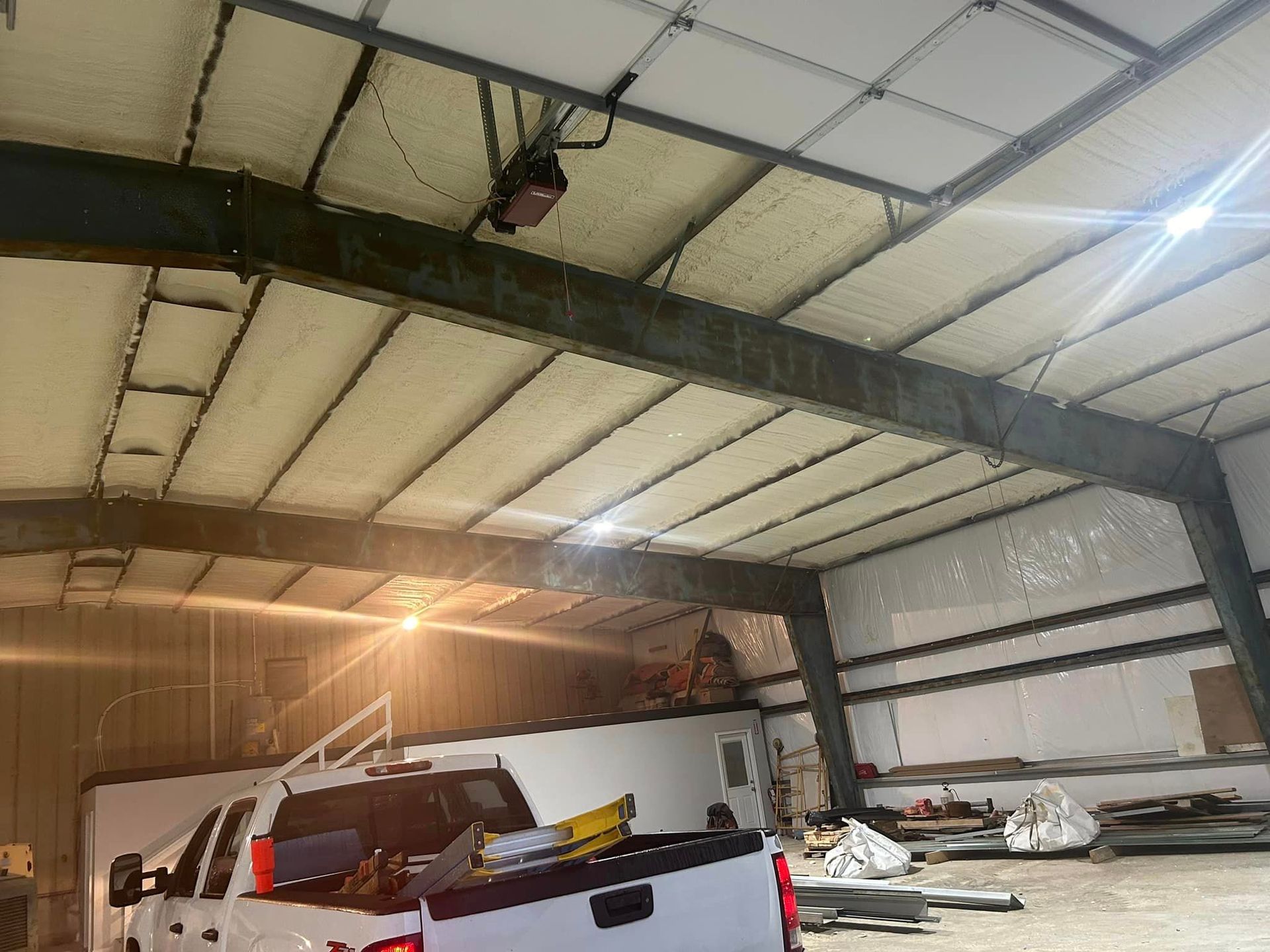 A truck is parked in the back of a large building.