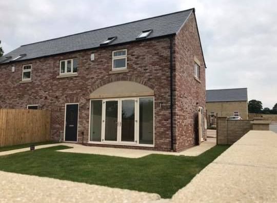 A brick house with a lot of windows and doors