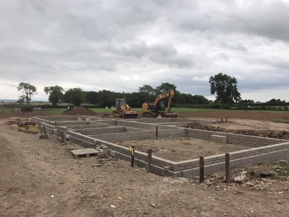 A construction site with a bulldozer in the background.
