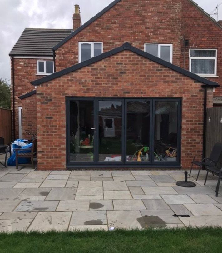 A brick house with a patio in front of it