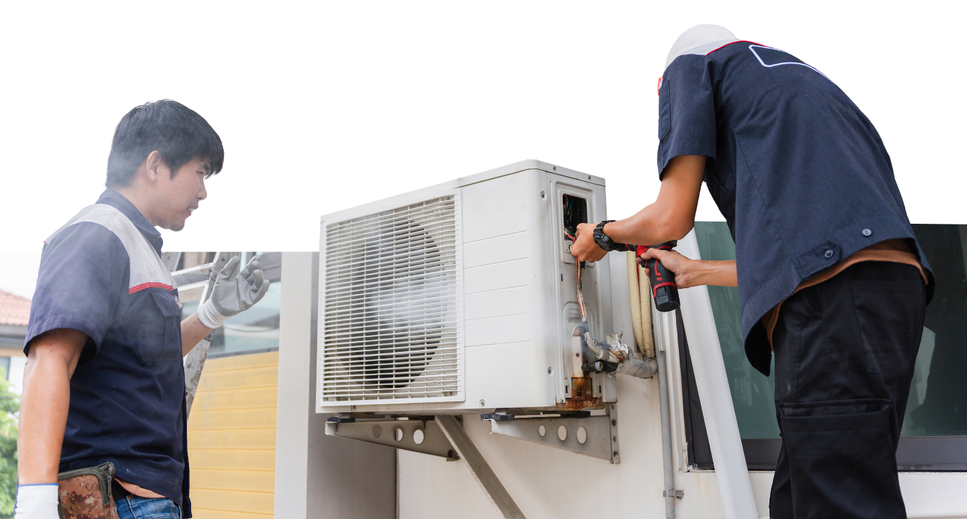 Two technicians in uniform installing or repairing an outdoor air conditioning unit.