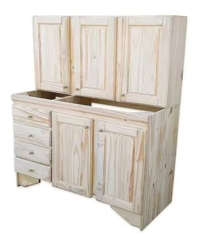 Tocador de baño de madera sin terminar con gabinetes, cajones y espacio de encimera abierto, sobre un fondo blanco.