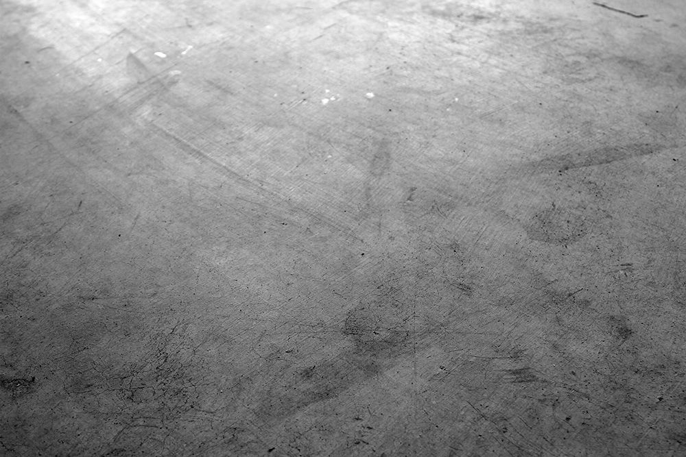 A black and white photo of a concrete floor.
