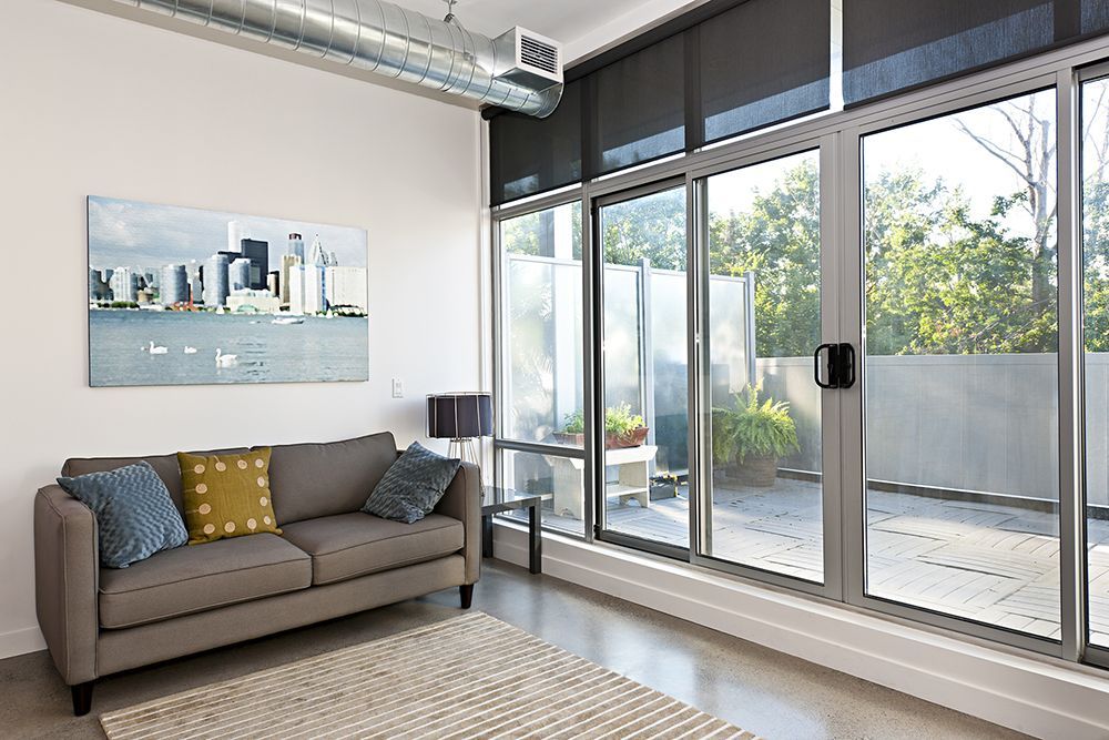 A living room with a couch and a large window