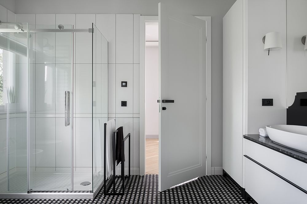 A bathroom with a walk in shower and a sink.