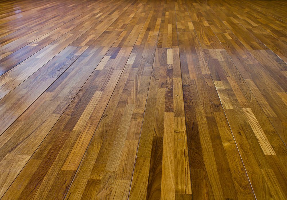 A close up of a wooden floor in a room.