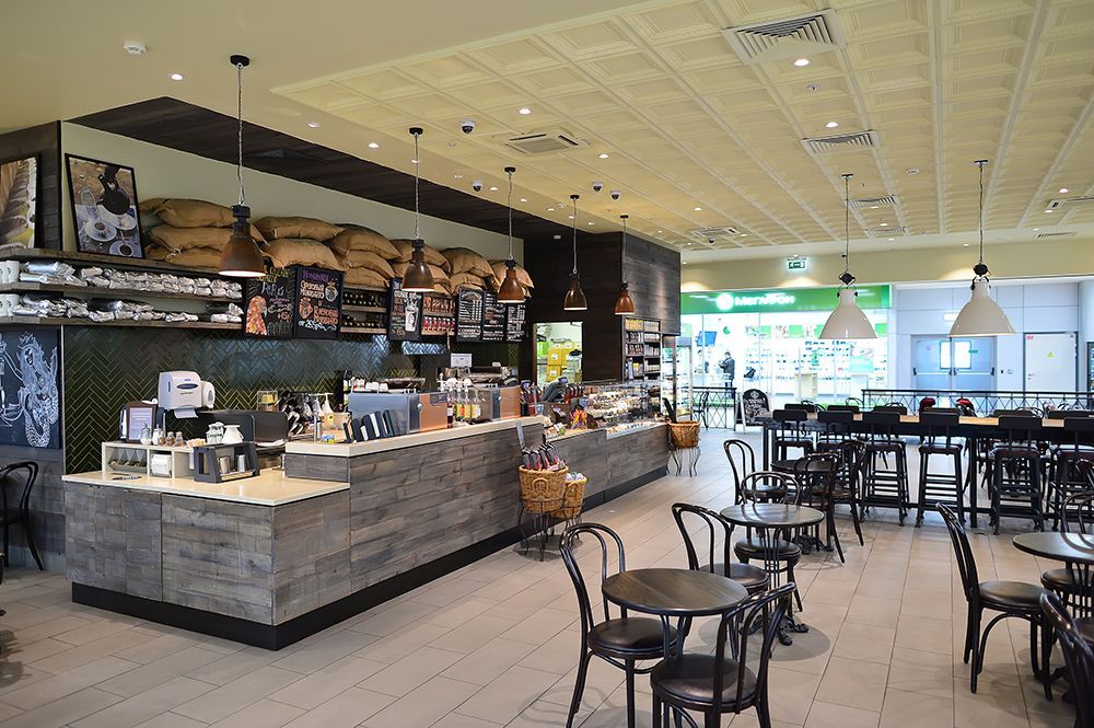 A restaurant with tables and chairs and a counter