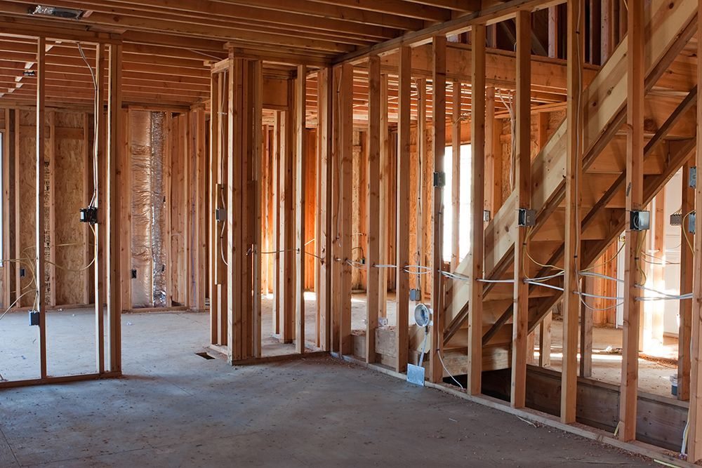 A house is being built with wooden beams and stairs.