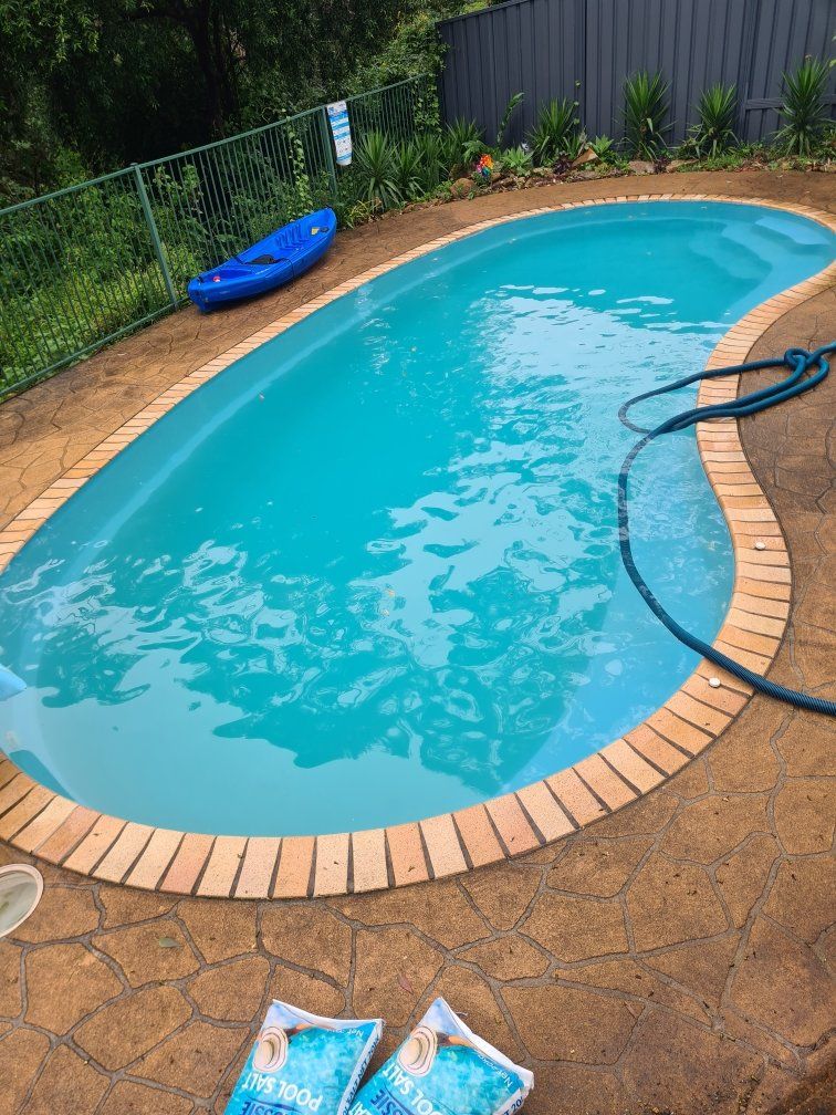 A swimming pool with a hose on the side | Penrith, NSW | Ian’s Pools Penrith