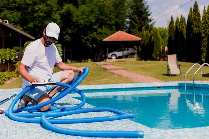 A man with white cloth ready to clean the swimming pool | Penrith, NSW | Ian’s Pools Penrith