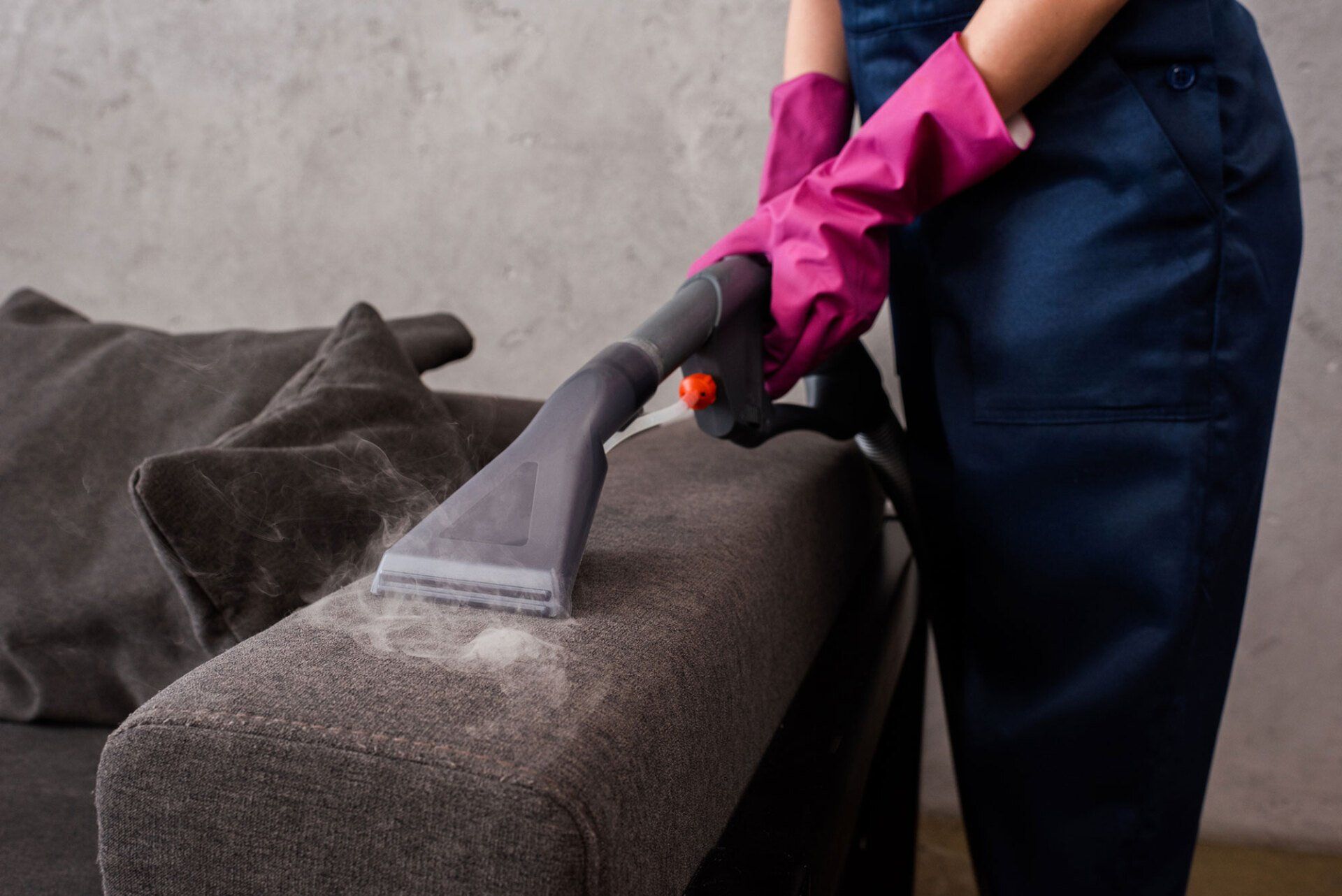 Vacuum Cleaner with Hot Steam on Couch Upholstery — Olympia, WA — Blue Ribbon Carpet & Upholstery Cleaning Vacuum Cleaner with Hot Steam on Couch Upholstery — Olympia, WA — Blue Ribbon Carpet & Upholstery Cleaning