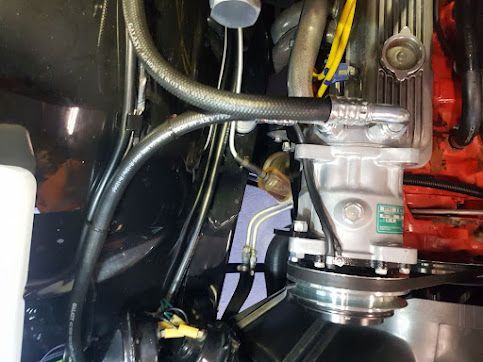 A Close Up Of A Car Engine With A Hose Attached To It — Airborne Auto Air in The Entrance, NSW