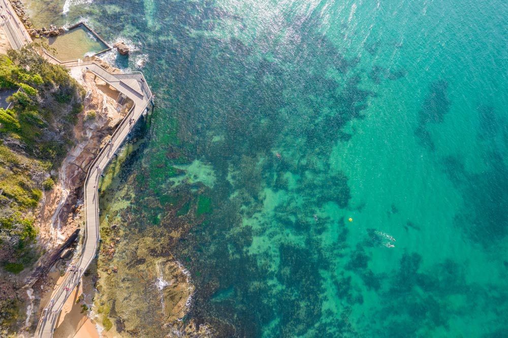 An Aerial View Of A Body Of Water With A Road Going Through It — Airborne Auto Air in Hamlyn Terrace, NSW