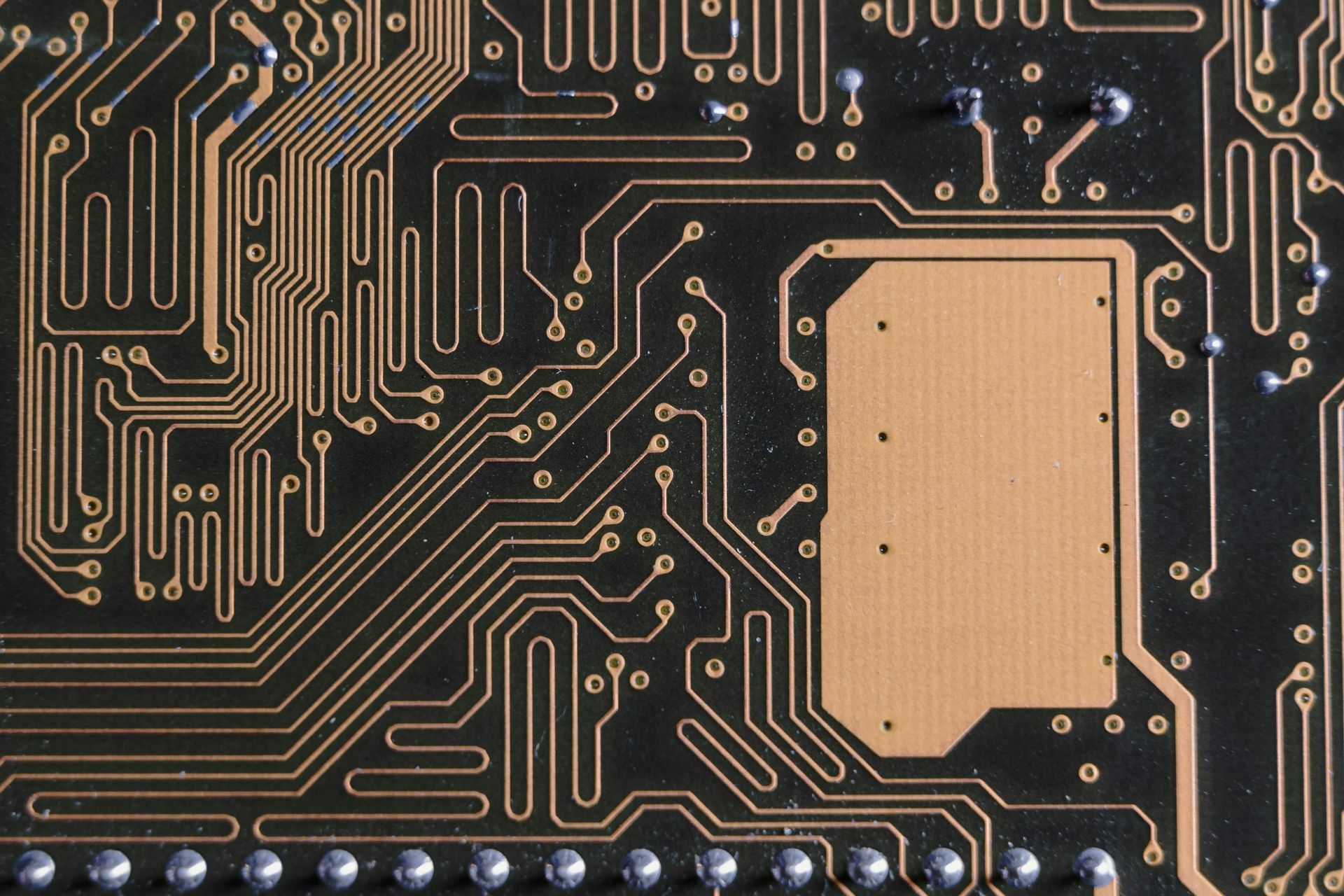 A close up of a computer circuit board with a square in the middle