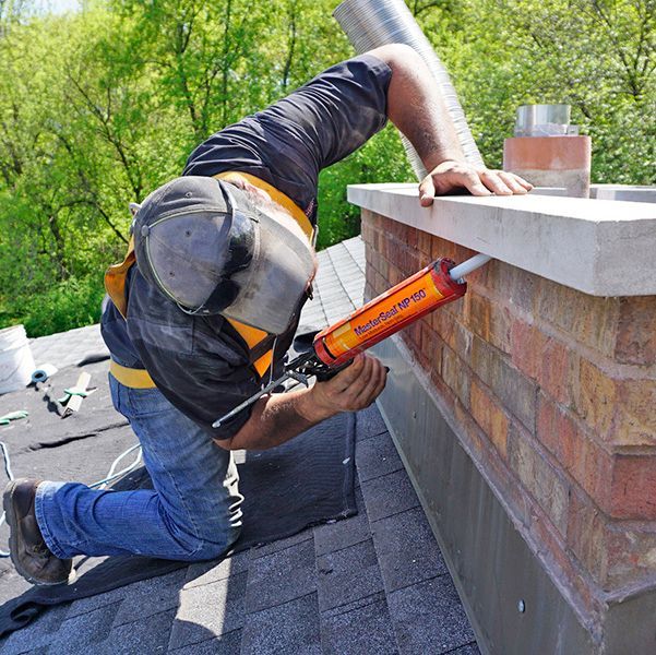 A high pressure washer is spraying water on a pipe.