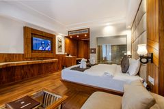 A hotel room with a large bed , couch , and television.