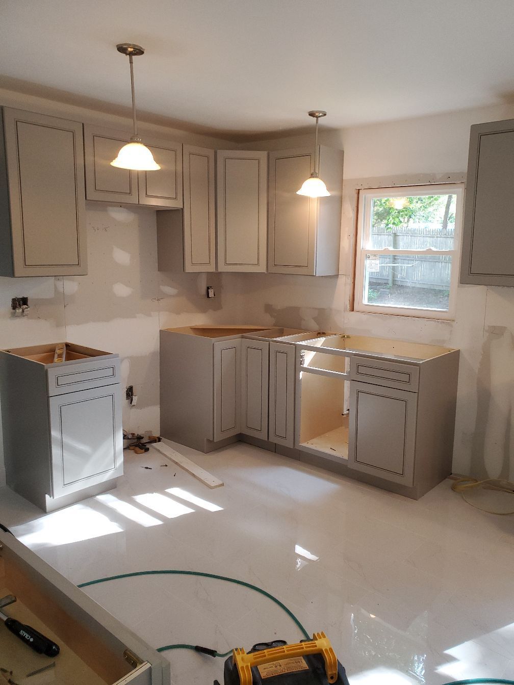 A kitchen with wooden cabinets , granite counter tops , stainless steel appliances and a large island.