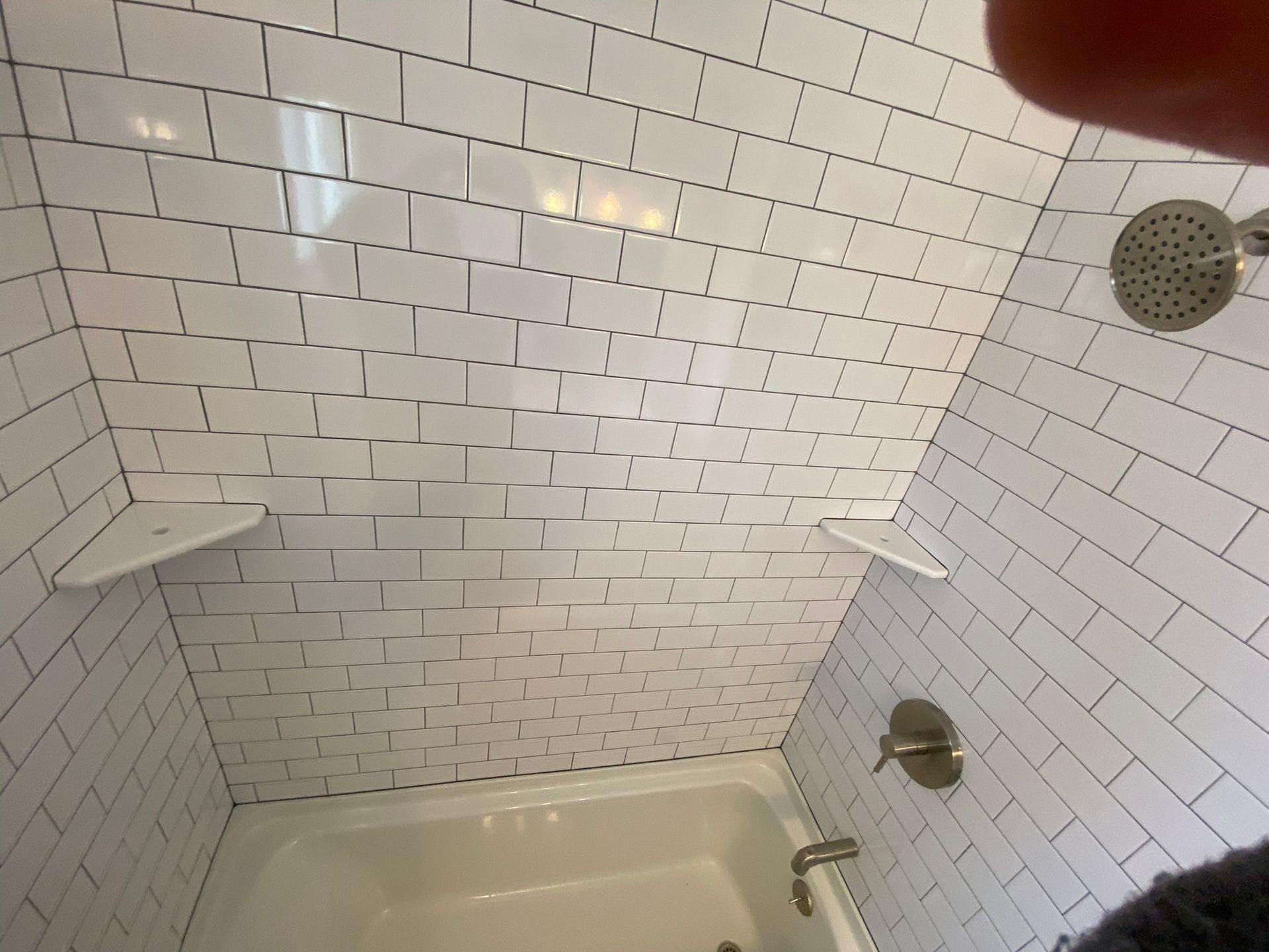 A bathroom with a bathtub , sink , toilet and shower.