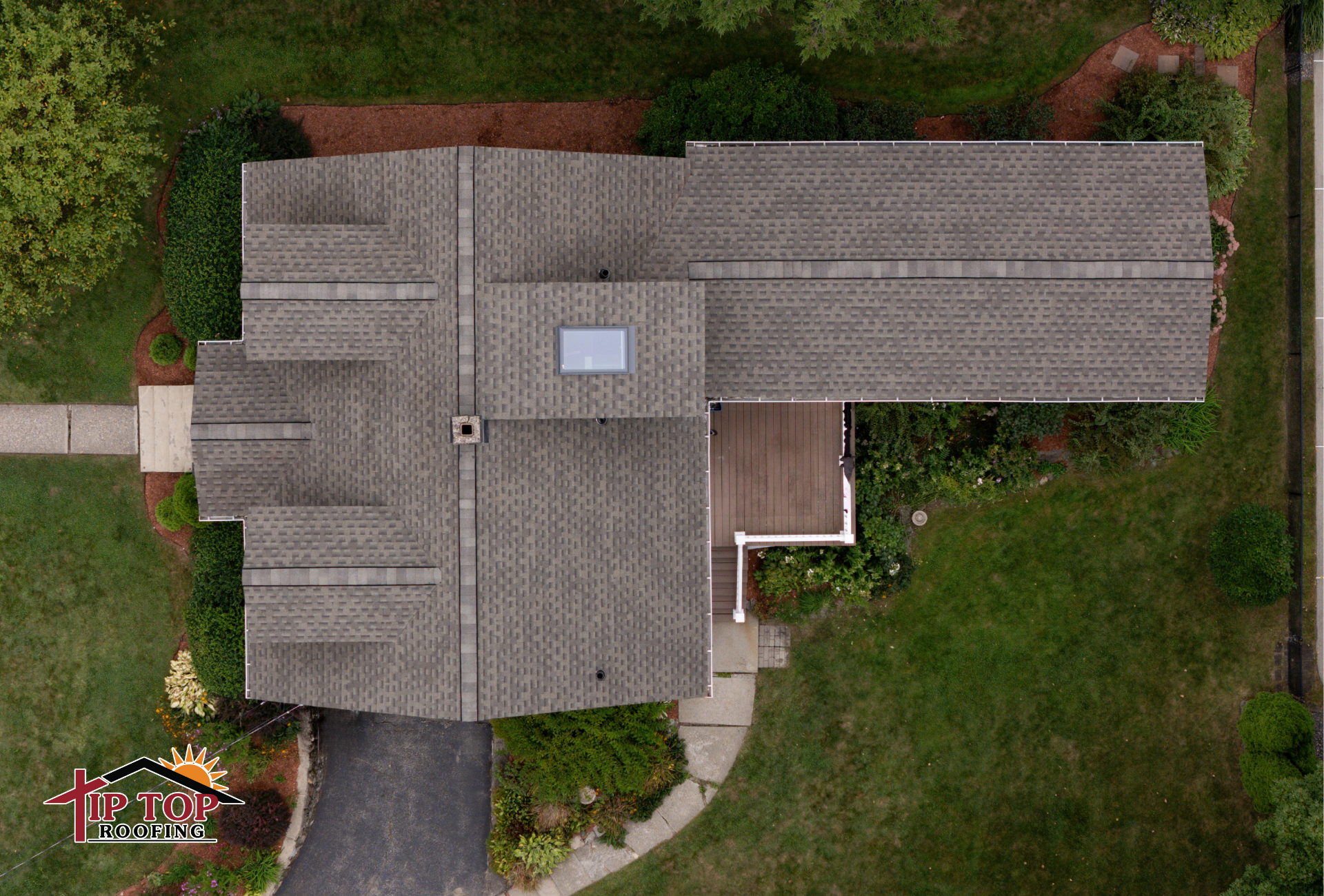 Residential architectural shingle roof viewed from above.