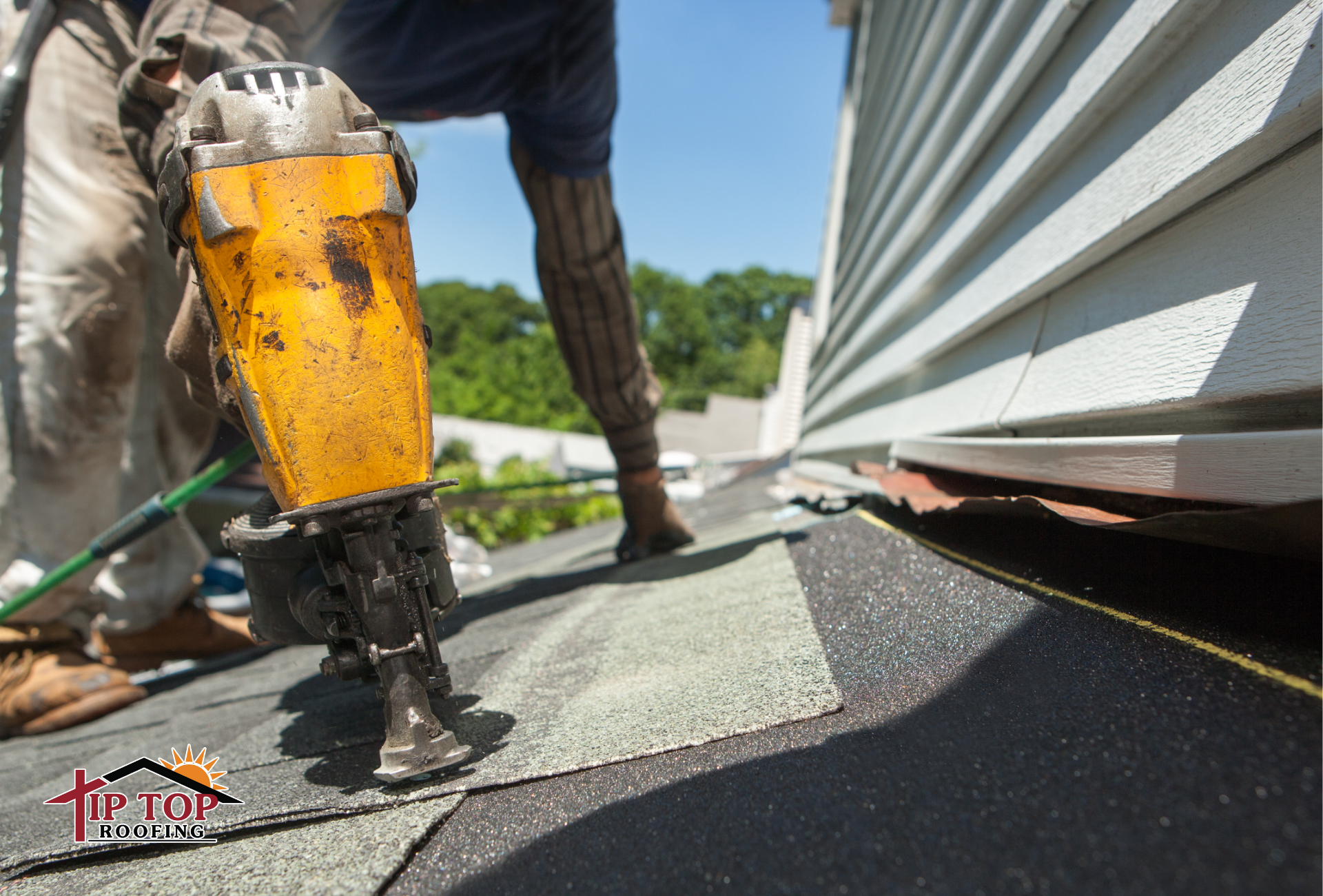 Roofing contractor installing architectural shingles during a residential roof replacement.