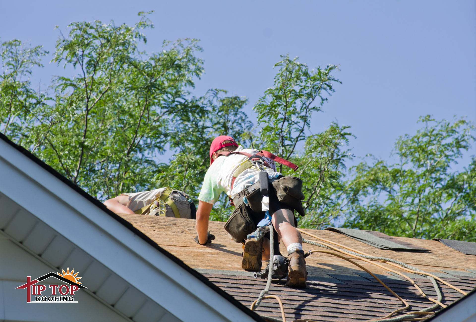 A roofing contractor working on a residential roof during a roof replacement