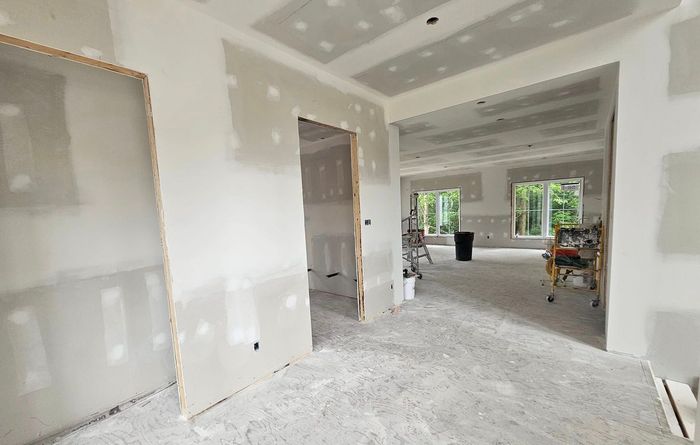 Une pièce dans une maison en construction avec des cloisons sèches sur les murs.